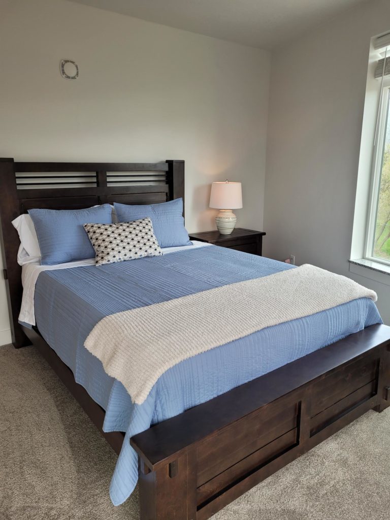 Mill Creek apartment bedroom with a blue bed.