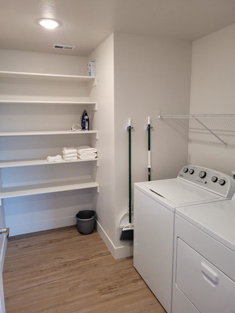 Mill Creek apartment laundry room with a washer and dryer.